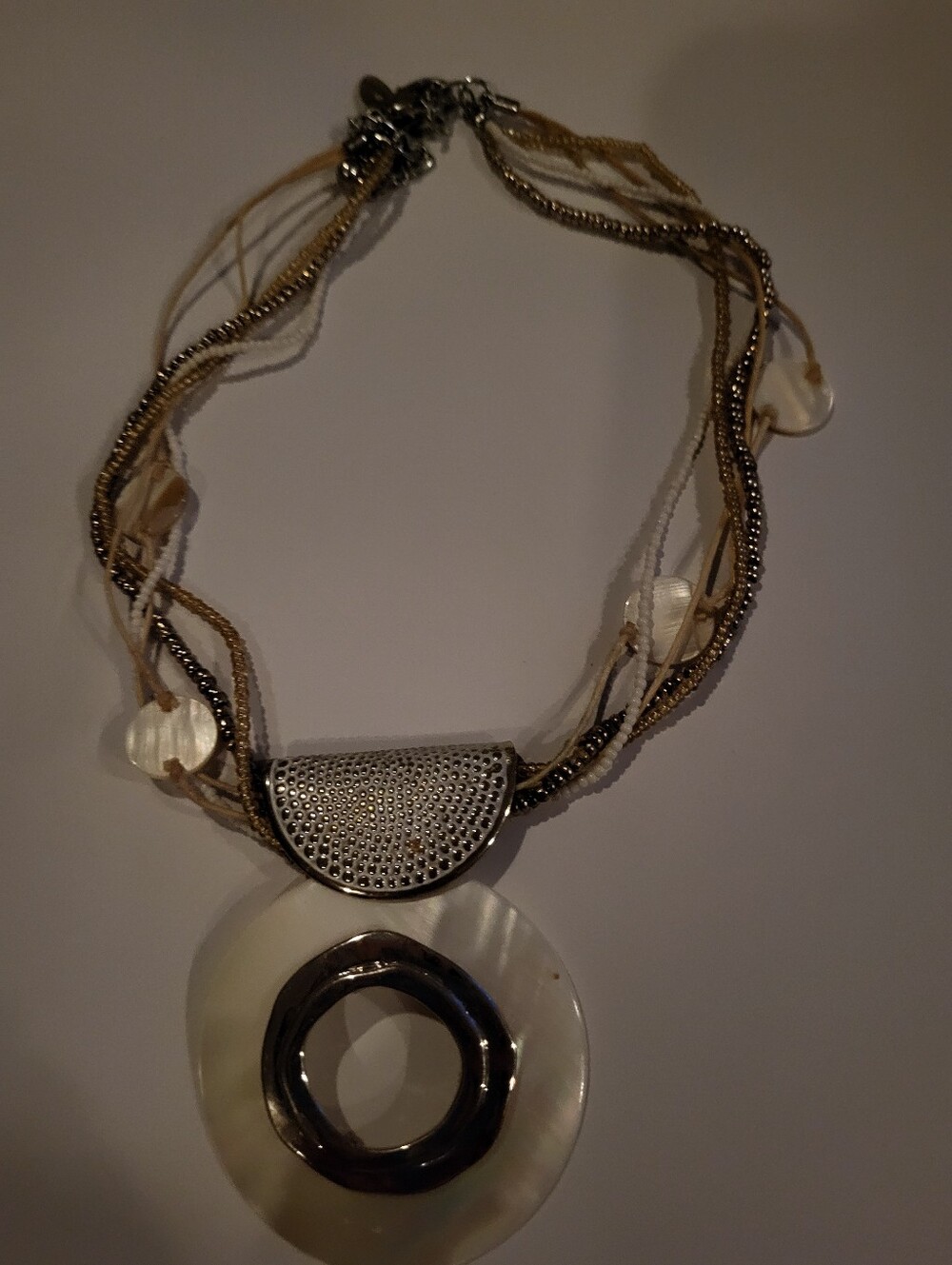 boho-chic multi-strand statement necklace features a blend of mixed media